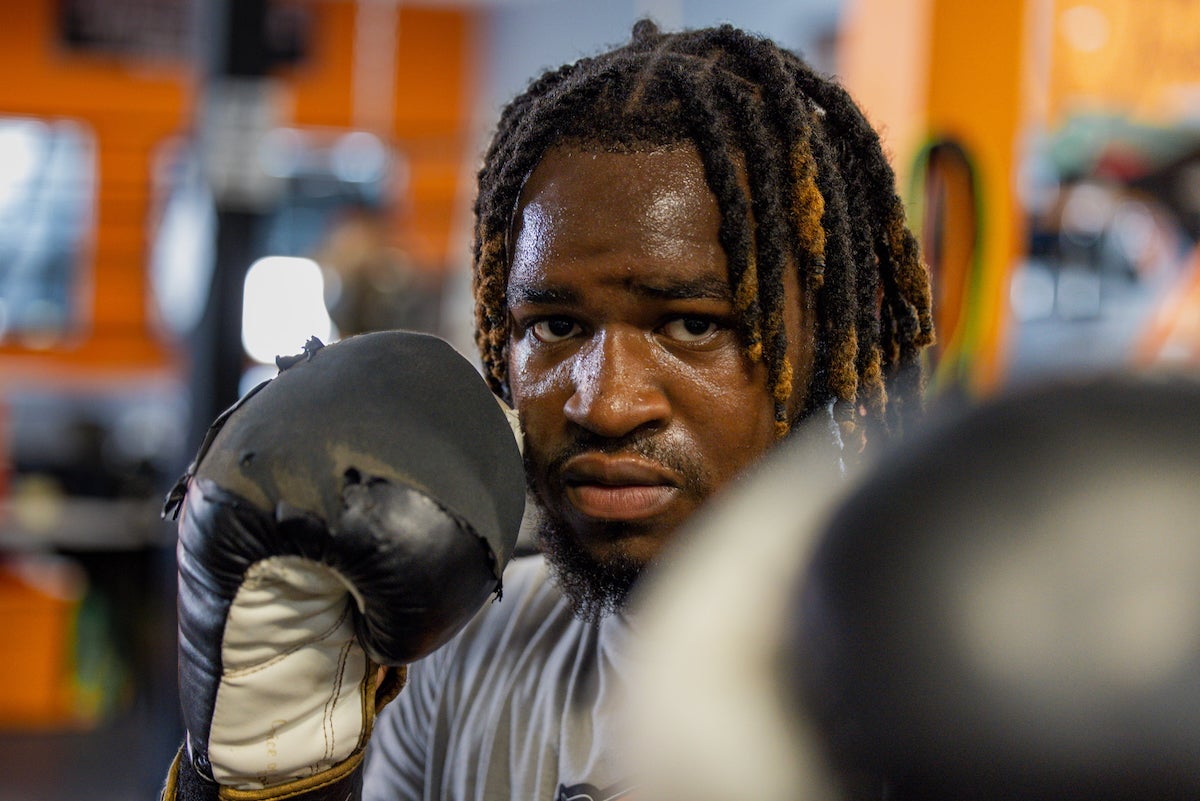 A close-up photo of 16-year-old D'Andre Marks with boxing gloves on during the Guns Down, Gloves Up summer camp at the Ike Williams Boxing Academy in Trenton on July 24, 2025.