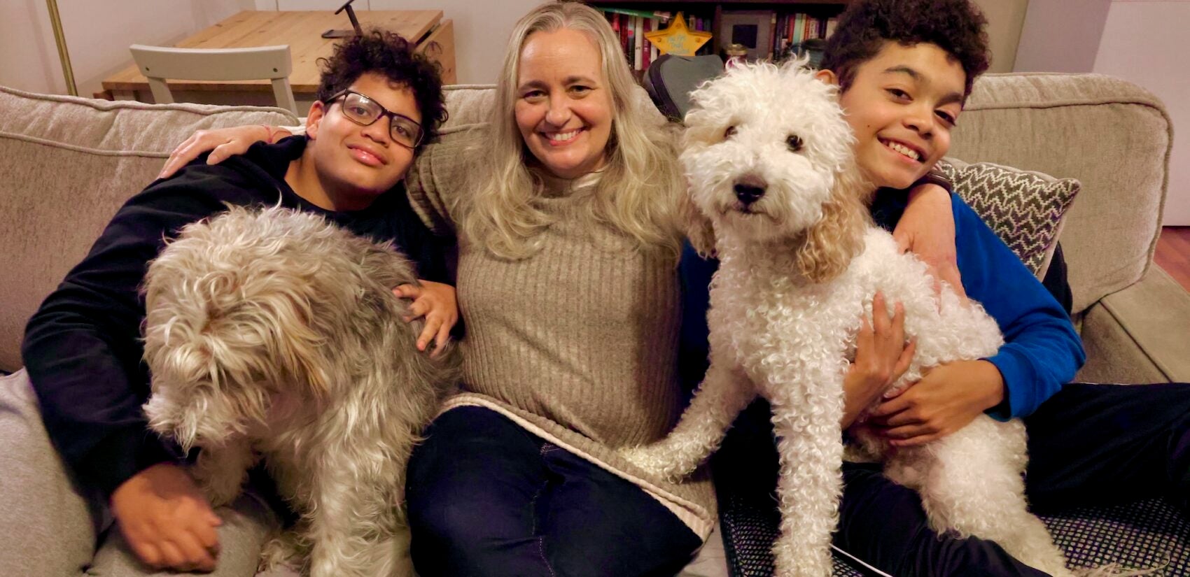 A family poses for a photo with their dogs