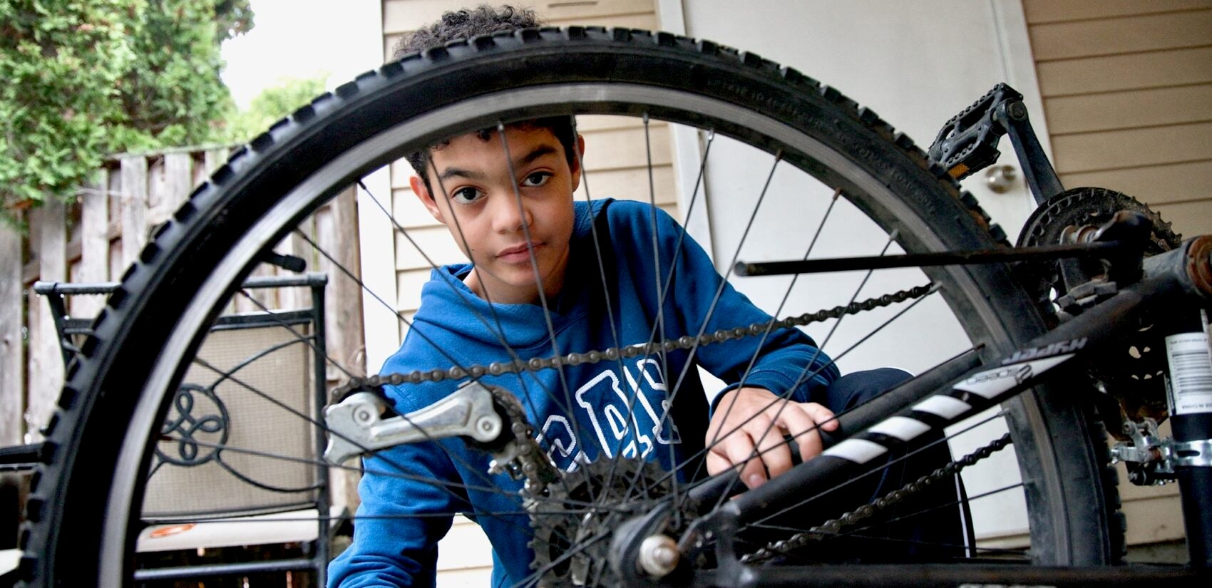 A child working on his bicycle