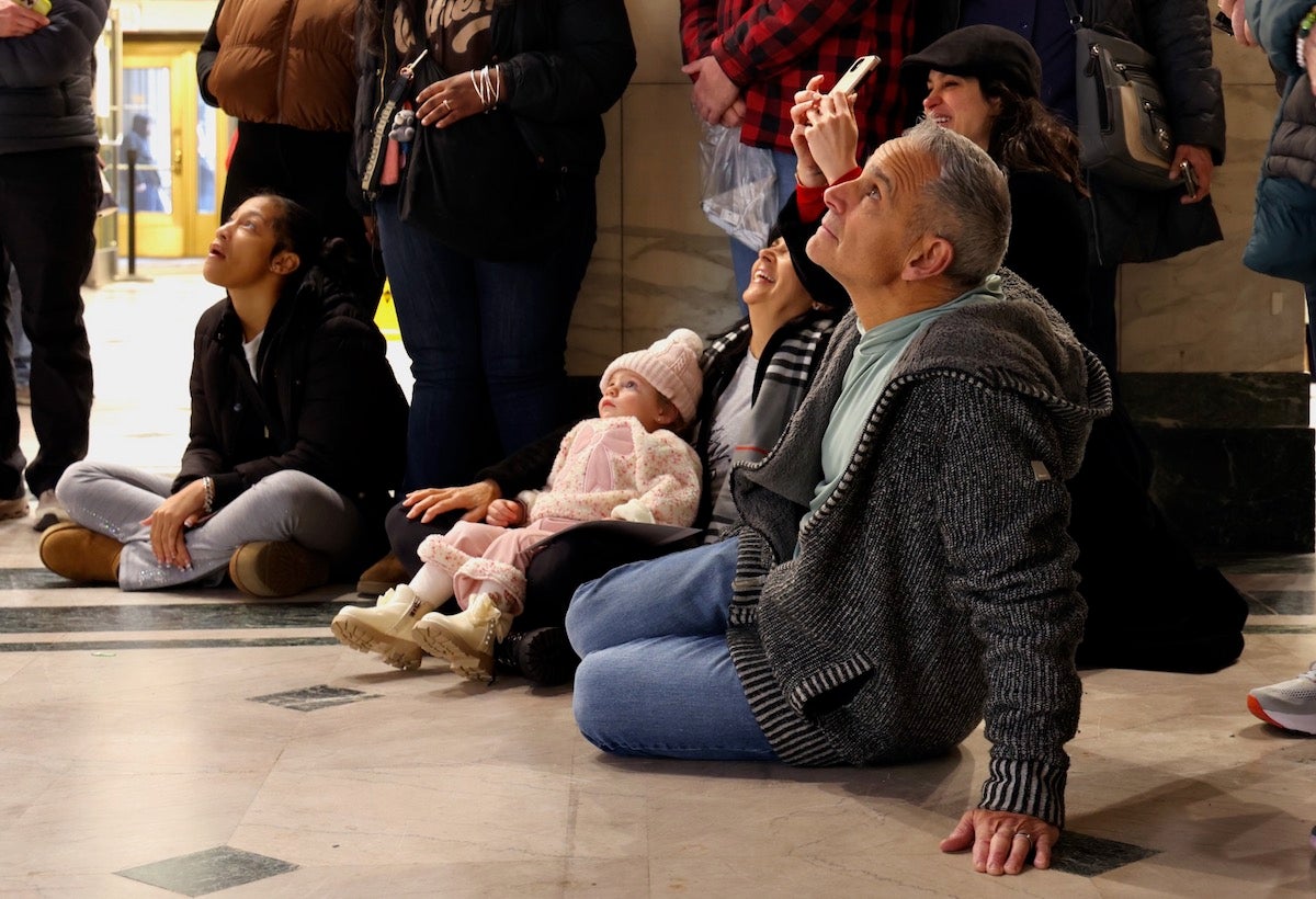 Crowd enjoying the Christmas light show at the Wanamaker Building