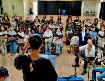 Conductor Laura Harmon leads singers with the Philadelphia Youth Choral Ensembles