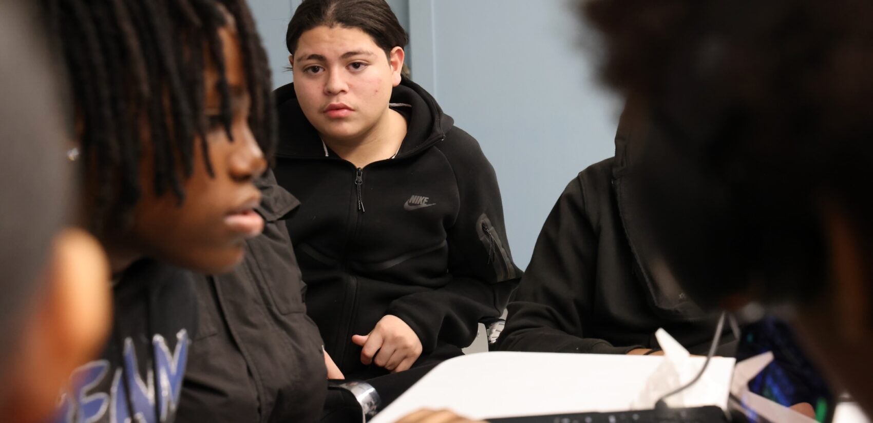 Christopher Briones working while sitting at a computer in the classroom