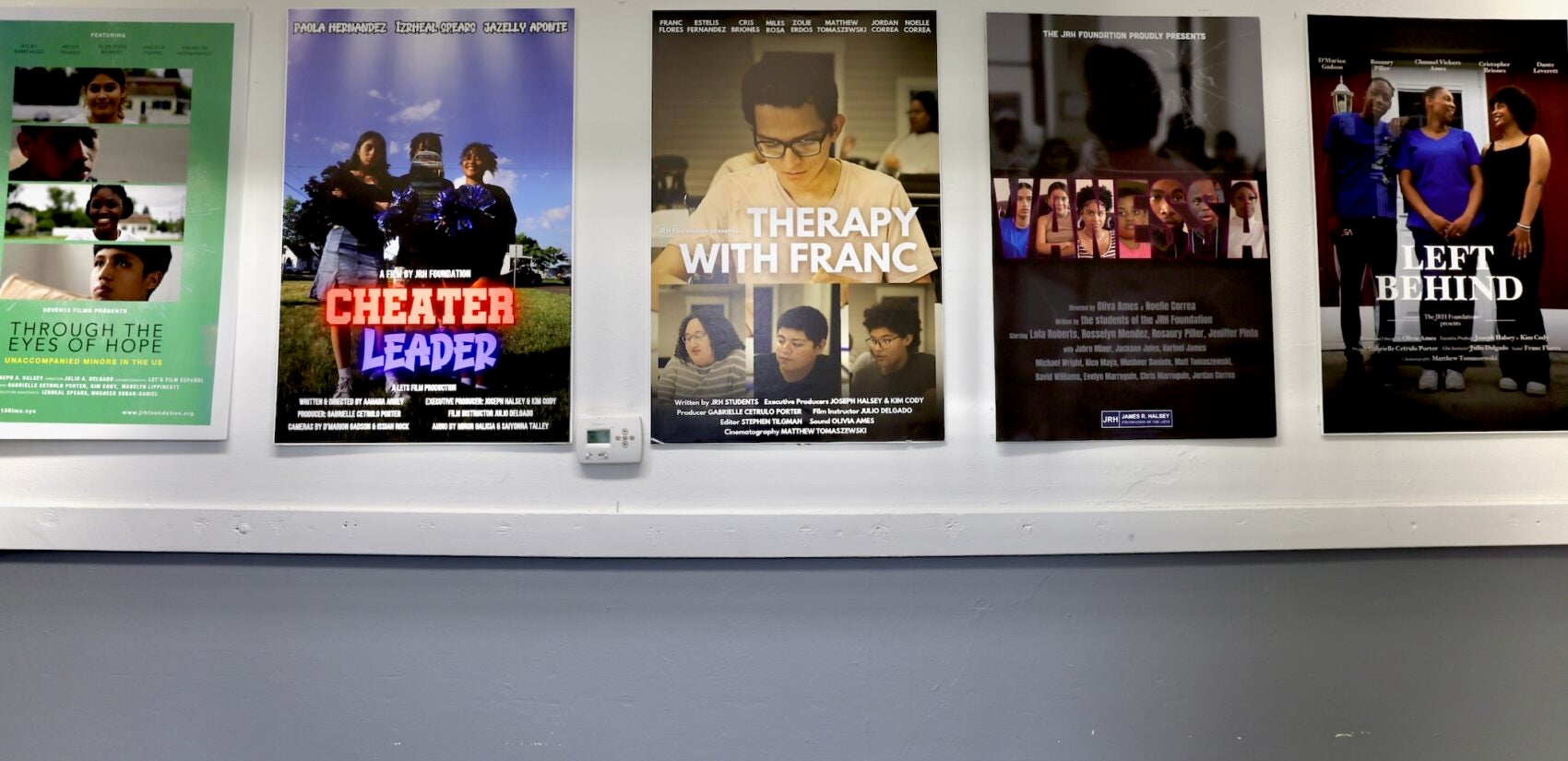 Five movie posters hanging on the wall in a hallway