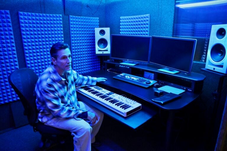 Joseph Halsey in in a dark studio room, with sound equipment