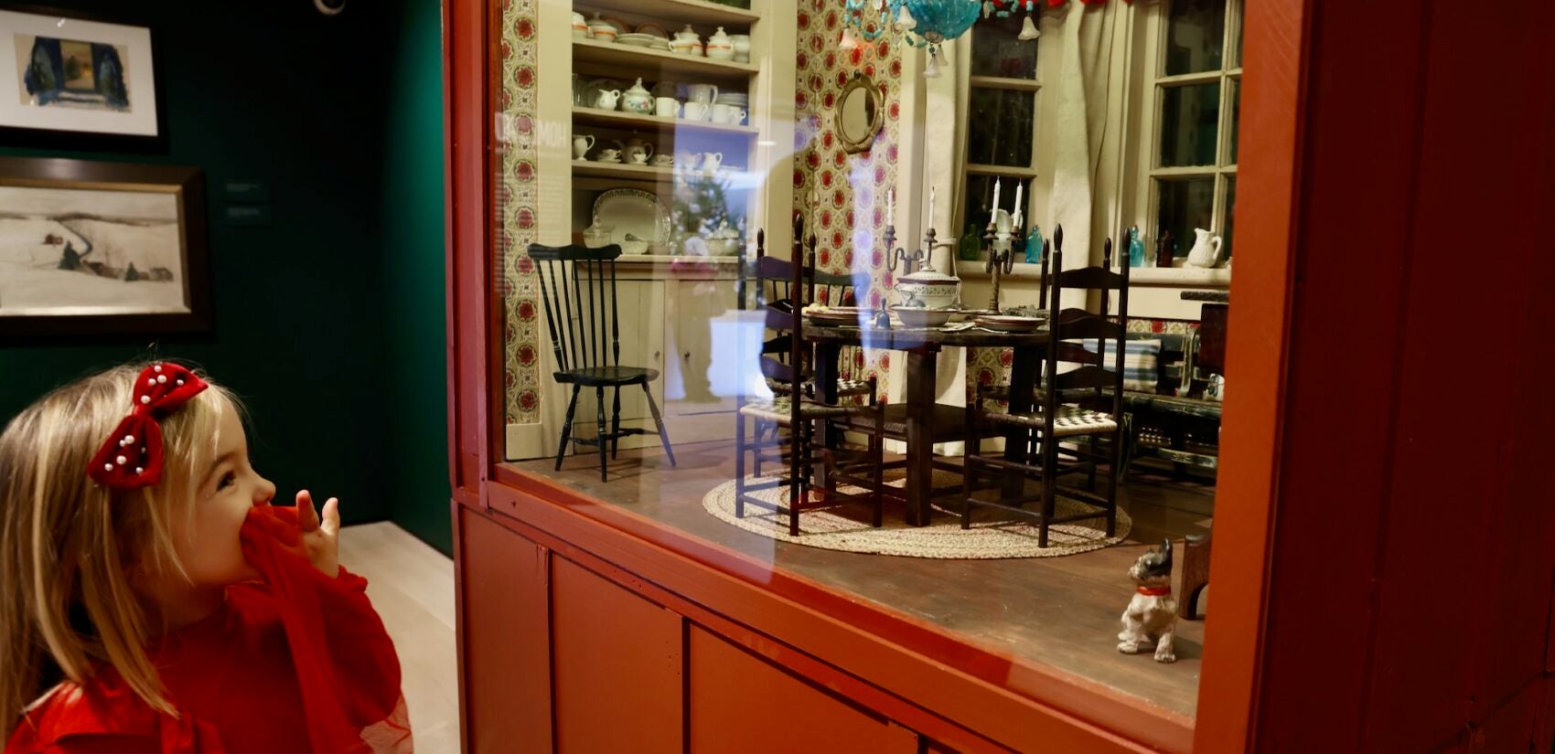 A child delights at the sight of the elaborately detailed dining room ofAnn Wyeth McCoy's dollhouse,