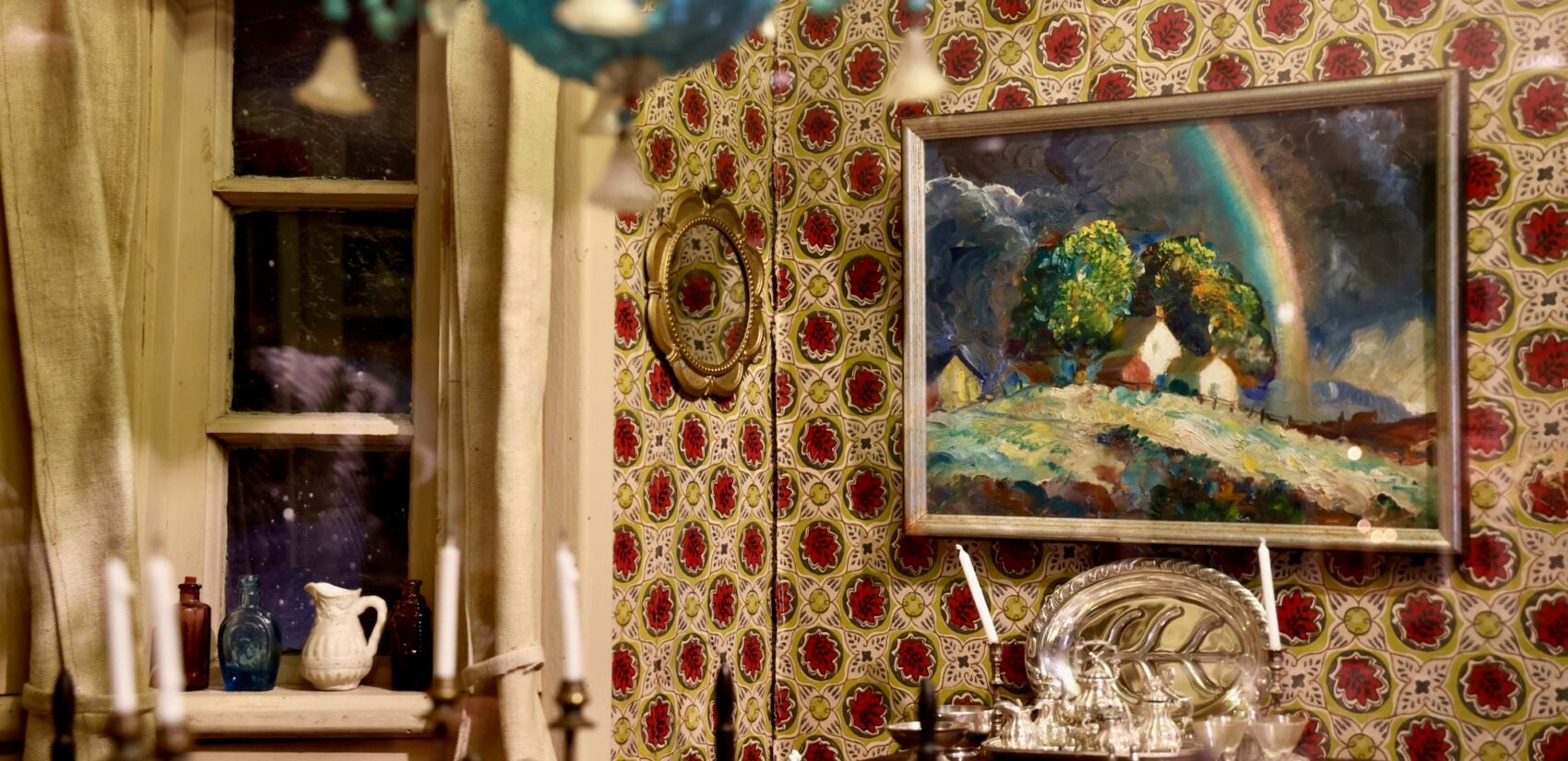 An original miniature painting by Peter Hurd adorns the dining room wall in Ann Wyeth McCoy's dollhouse