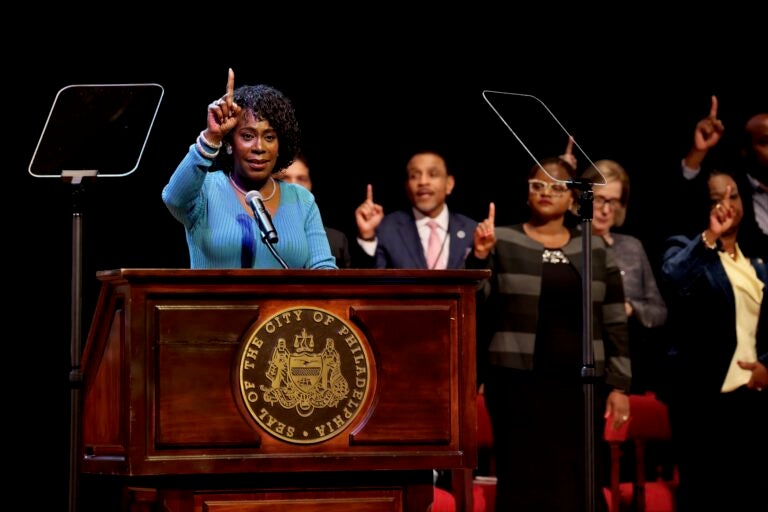 Cherelle Parker raises one finger in the air as she stands at the podium delivering her address at Temple University