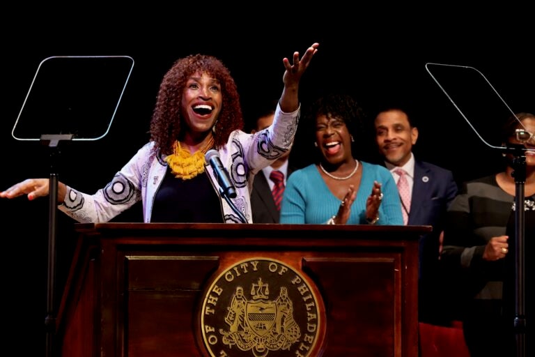 Val Gay is on stage singing 'Lift Every Voice and Sing' with Mayor Cherelle Parker standing behind her