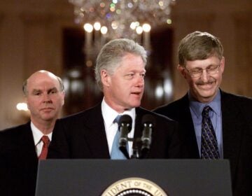 President Clinton, flanked by Celera Genomics head J. Craig Venter, left, and Francis Collins, head of the Human Genome Project of the National Institutes of Health, meets reporters in the East Room of the White House Monday, June 26, 2000 to announce that the two teams have completed a rough draft of the human genetic code. (AP Photo/Rick Bowmer)