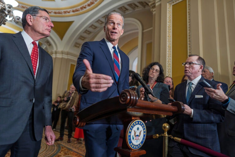 Senate Majority Leader John Thune, R-S.D., joined at left by Sen. John Barrasso, R-Wyo., speaks to reporters after a closed-door meeting with fellow Republicans