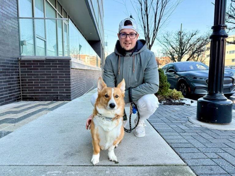 Lourens Loock poses with his Corgi, Benjamin
