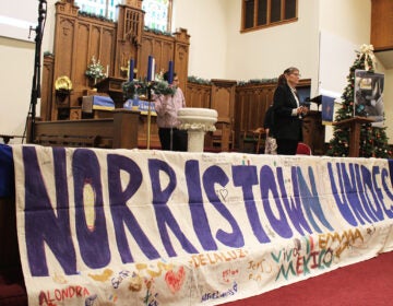 Members of Montco Community Watch and Pennsylvania Immigration Coalition standing on stage