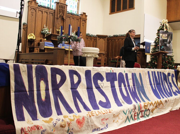 Members of Montco Community Watch and Pennsylvania Immigration Coalition standing on stage