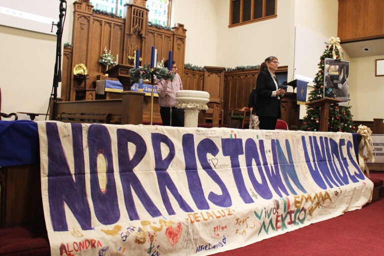 Members of Montco Community Watch and Pennsylvania Immigration Coalition standing on stage