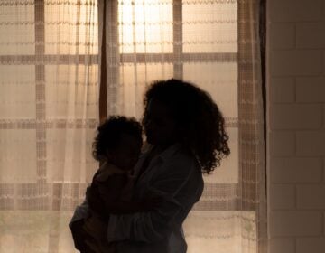 Mother and children enjoy the morning sunlight shining through the bedroom window in the house. Mother and children enjoy the morning sunlight shining through the bedroom window in the house.