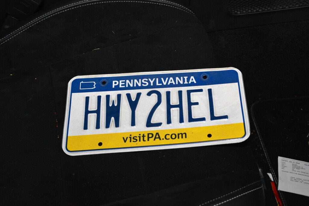 A license plate says 'HWY2HEL'