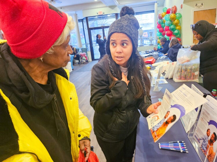 Laura Polo talking with fair attendee about health insurance