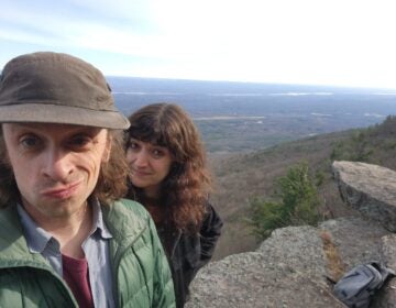 walnut_brain-2025-12-13-2 A selfie photo of Steve Heise and Alina Josan standing on a large hill overlooking a wide landscape