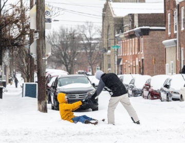 A resident gets a hand out of the snow in Philadelphia’s Fishtown neighborhood on Jan. 25, 2026.