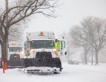 Snow plows on the street during a snowstorm