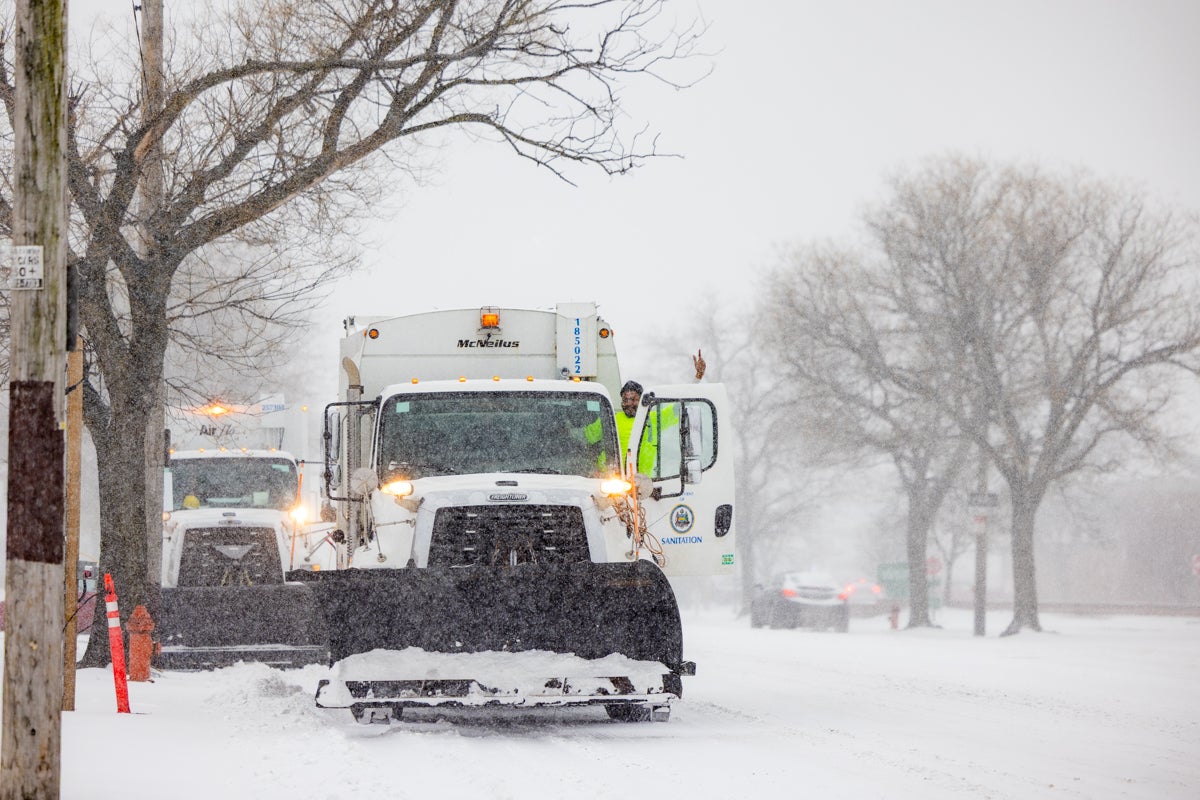 Snow plows on the street during a snowstorm