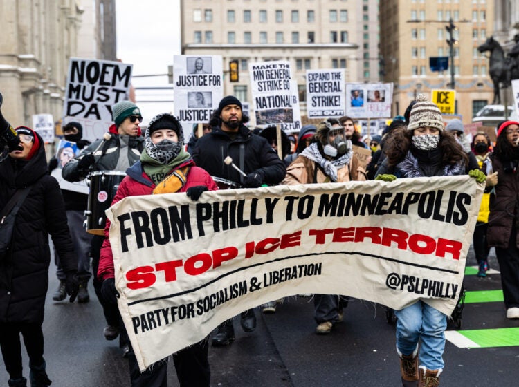 Protesters outside City Hall hold a banner reading FROM PHILLY TO MINNEAPOLIS STOP ICE TERROR