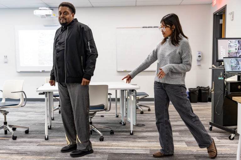 Stephanie Lorenzo shows off the magnetic and snap-closure seams she installed