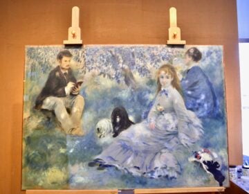 Pierre-Auguste Renoir's 1875 painting, ''The Henriot Family'' is undergoing conservation at The Barnes Foundation. A yellowed coat of resin is being removed, revealing a brighter, bluer painting long hidden. (Emma Lee/WHYY)