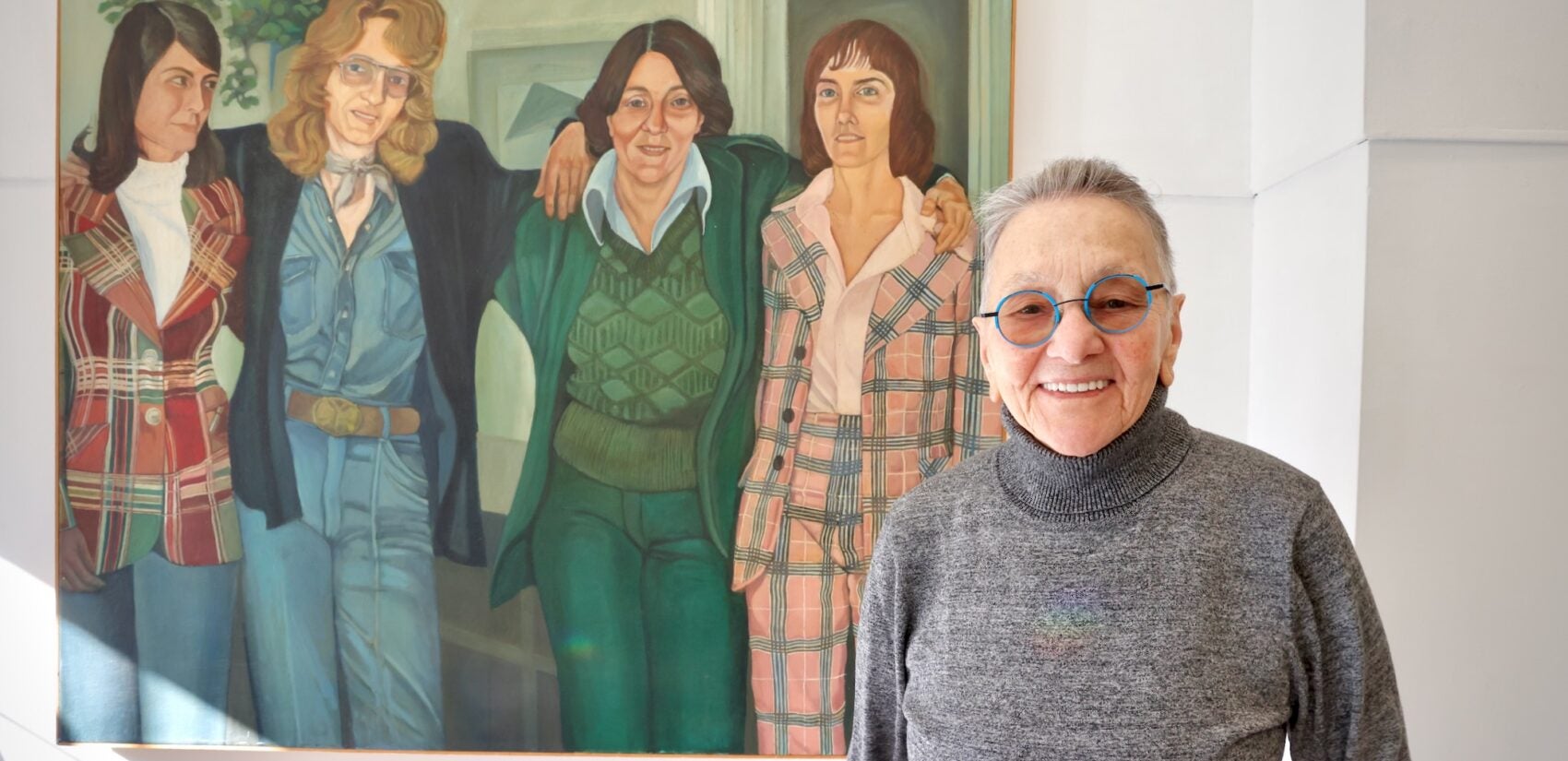 Arleen Olshan next to a painting