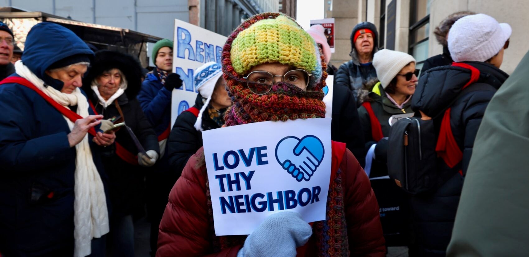 Ali Landers, holding a sign that says ''Love thy neighbor,'' marches with hundreds of protesters in Philadelphia calling for an end to raids by ICE agents