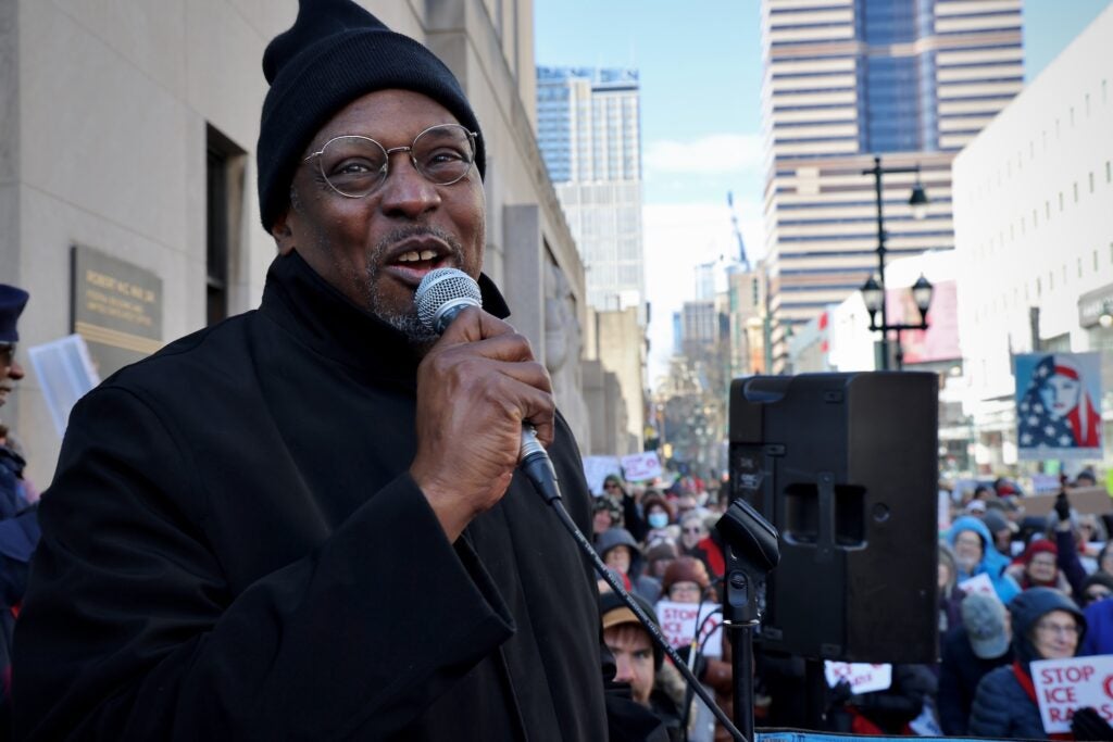 Rev. Greg Holston addresses hundreds of protesters as they prepare to march to the offices of the U.S. Immigration and Customs Enforcement in Philadelphia.