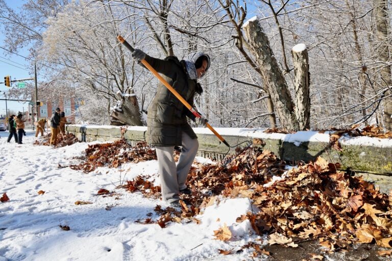A volunteer helps clean up the 52nd Street overpass in West Fairmount Park in Philadephia