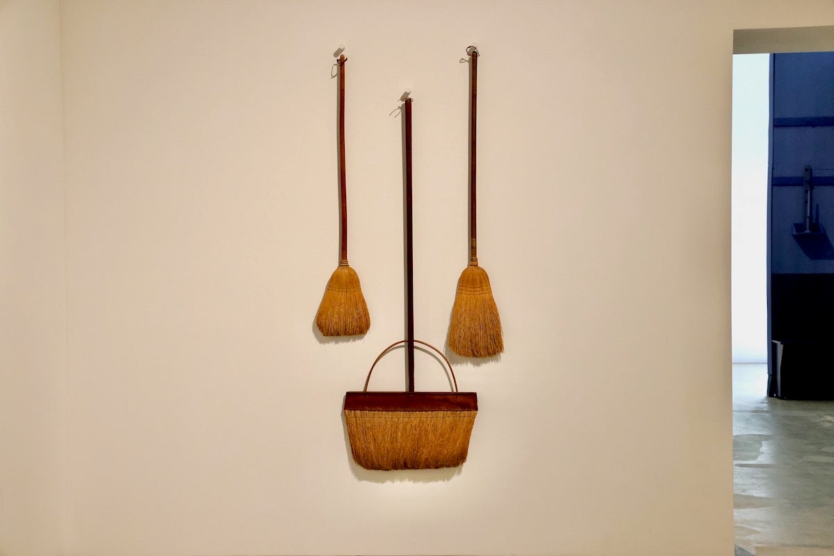 Vintage flat brooms on display