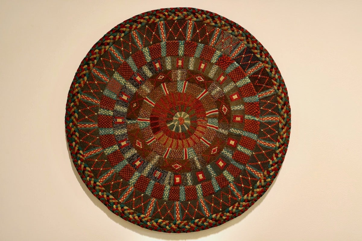 Hand crafted knitted wool rug on display