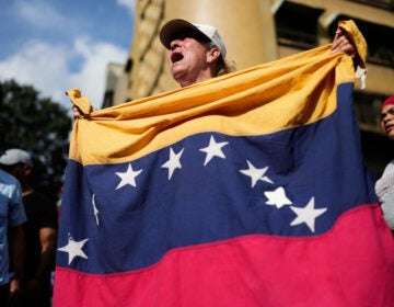 Venezuela US Government supporters rally in Caracas, Venezuela, Saturday, Jan. 3, 2026, after President Donald Trump announced that U.S. forces had captured Venezuelan President Nicolás Maduro and his wife. (AP Photo/Ariana Cubillos)