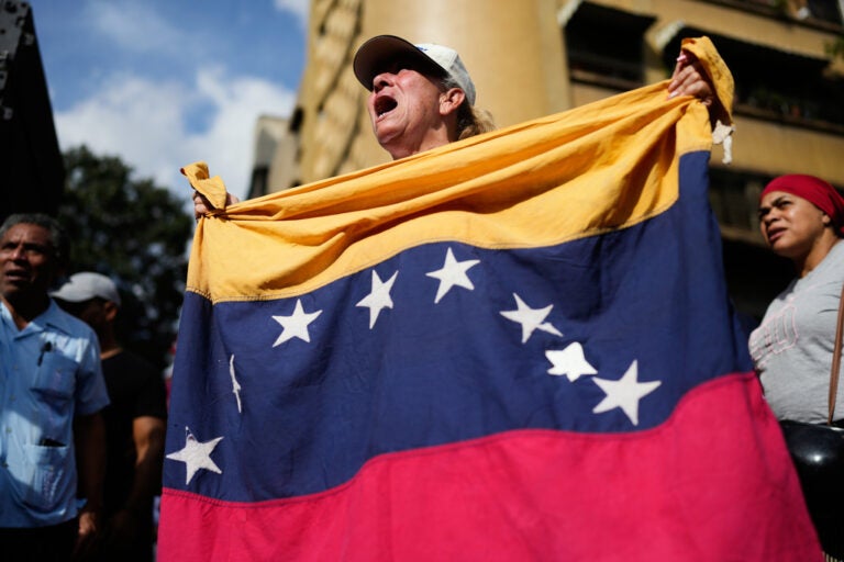 Government supporters rally in Caracas, Venezuela, Saturday, Jan. 3, 2026, after President Donald Trump announced that U.S. forces had captured Venezuelan President Nicolás Maduro and his wife. (AP Photo/Ariana Cubillos)
