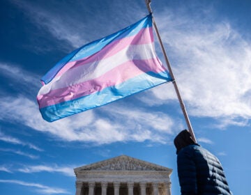 Supreme Court Transgender Athletes Protesters wave transgender pride flags outside the Supreme Court as it hears arguments over state laws barring transgender girls and women from playing on school athletic teams, Tuesday, Jan. 13, 2026, in Washington. (AP Photo/Julia Demaree Nikhinson)