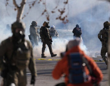 Federal immigration officers deploy tear gas at protesters