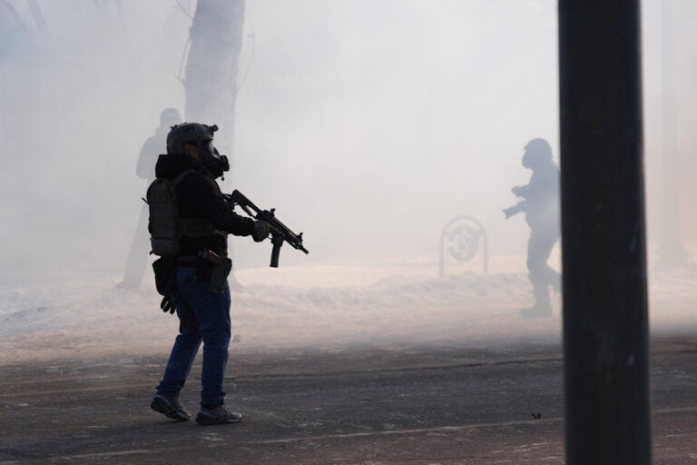 Federal immigration officers deploy tear gas after a shooting in Minneapolis