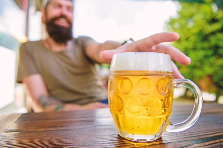A chilled beer mug on cafe table. (photosvit/bigstock)
