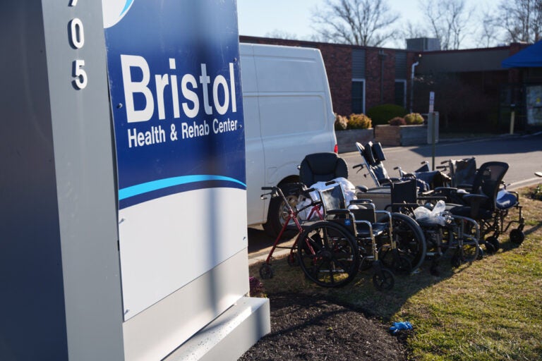 Wheelchairs and other debris are scattered amid structural damage after a massive explosion and fire caused a collapse at the nursing home in Bristol, Pennsylvania