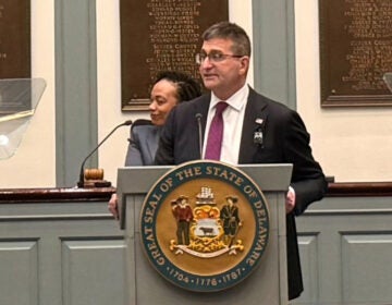 Matt Meyer standing at a podium giving a speech in Legislative Hall