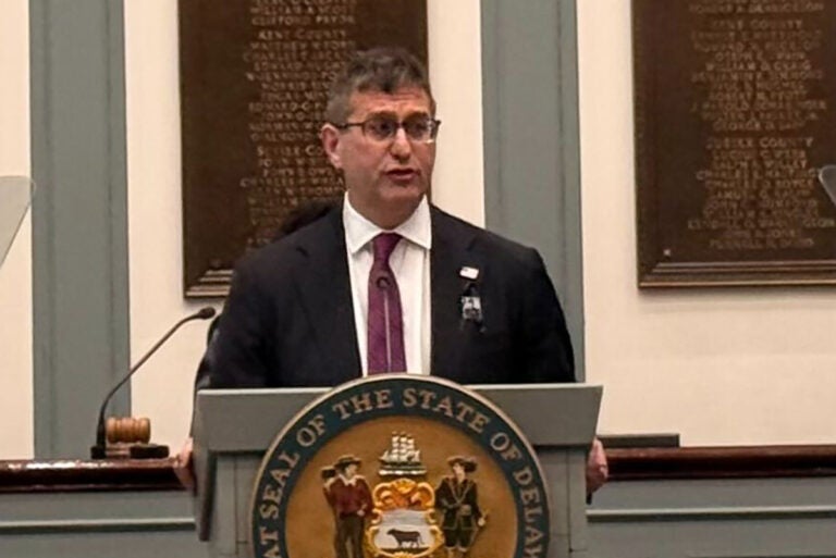Matt Meyer standing at a podium giving a speech in Legislative Hall