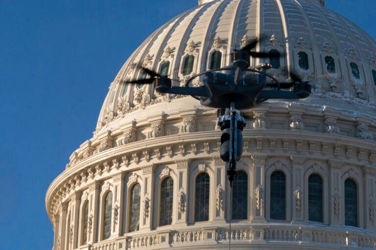 A drone tethered to a truck hovers near the U.S. Capitol