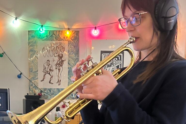Emily Robb playing a trumpet in the recording studio