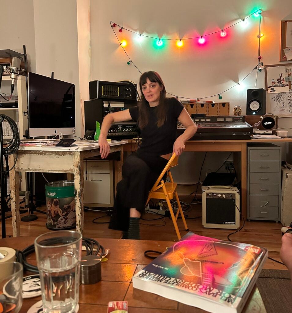 Emily Robb sitting at a desk in her recording studio