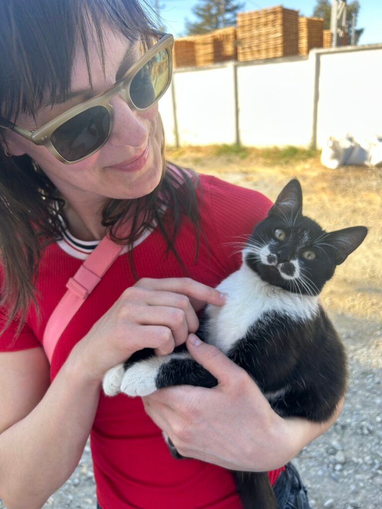 Emily Robb holding a stray cat.