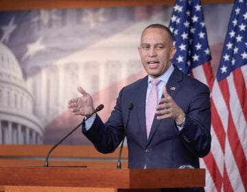 Hakeem Jeffries is speaking at a podium during a press conference on Capitol Hill