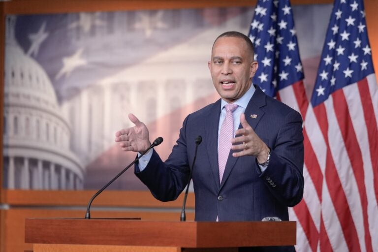 Hakeem Jeffries is speaking at a podium during a press conference on Capitol Hill