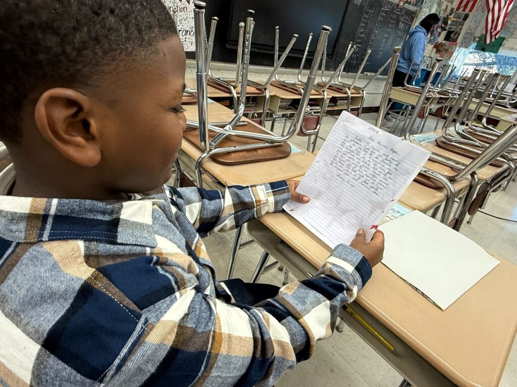 A Joseph M. McVey Elementary Schoo student holds a letter about wetland protection